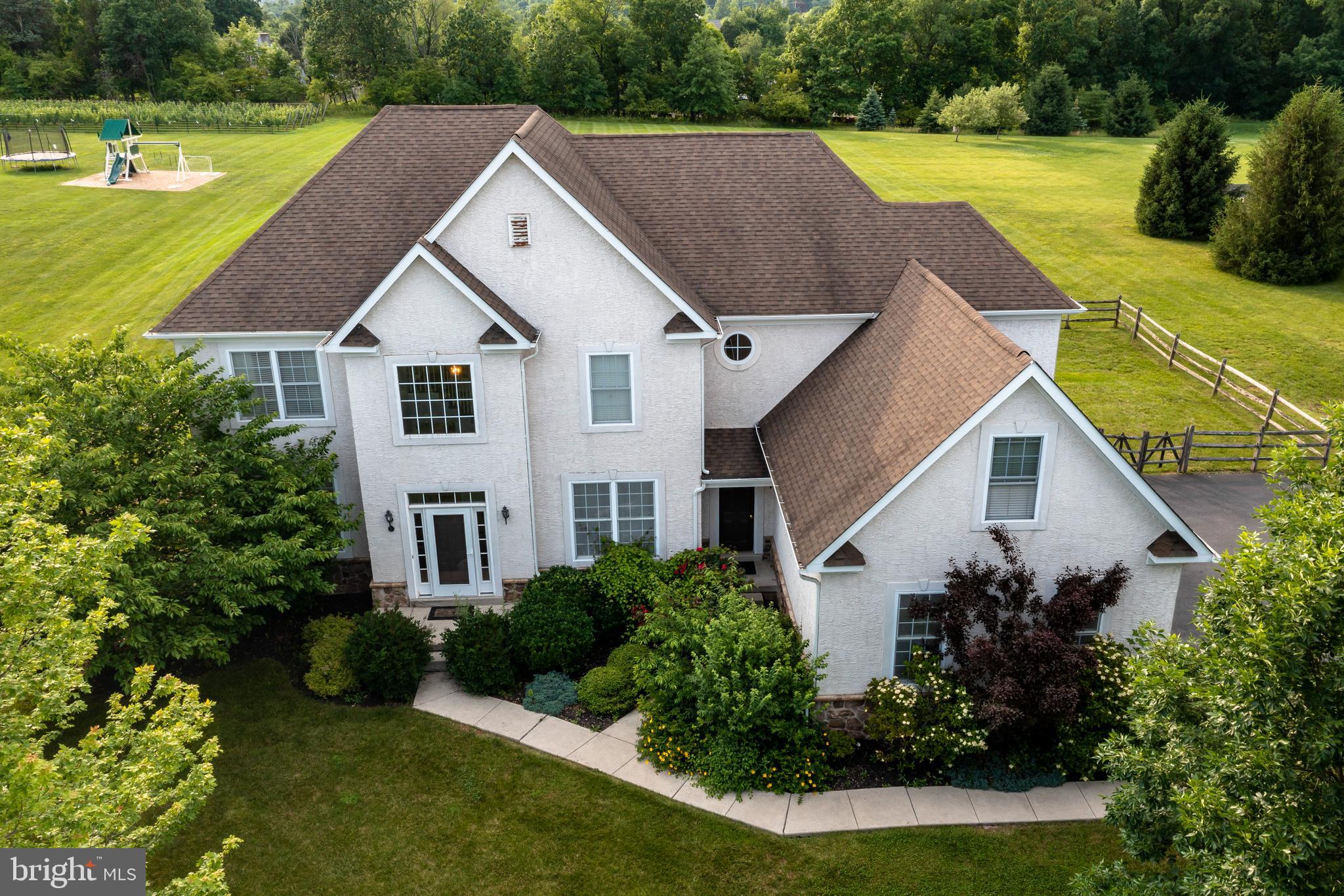 a aerial view of a house with a yard table and chairs