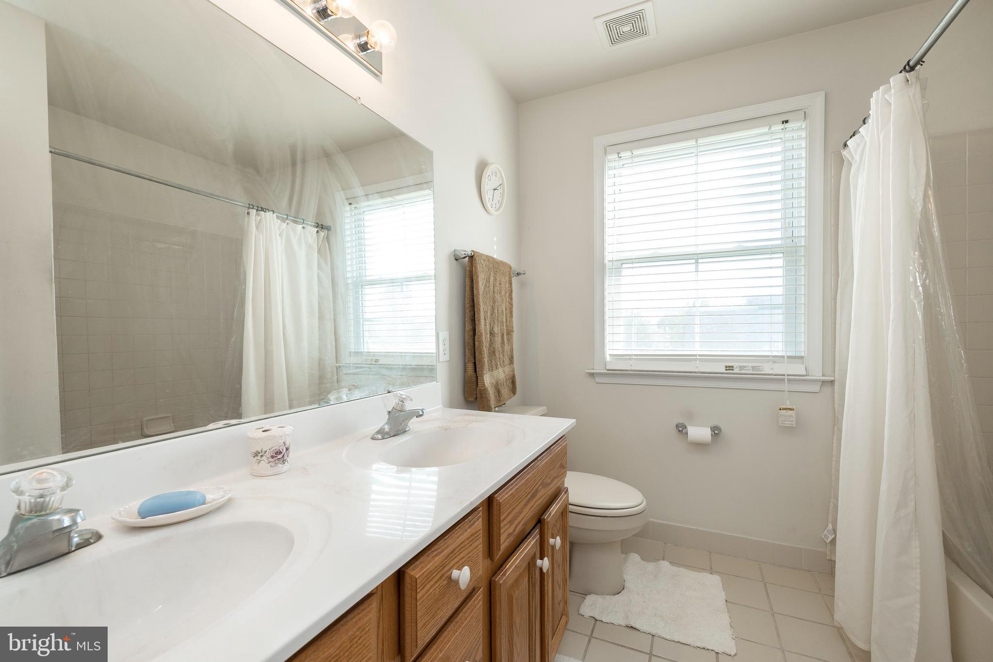 877 Church Road Harleysville, PA 19438 - Photo 13 of 48 a bathroom with a granite countertop sink toilet and shower