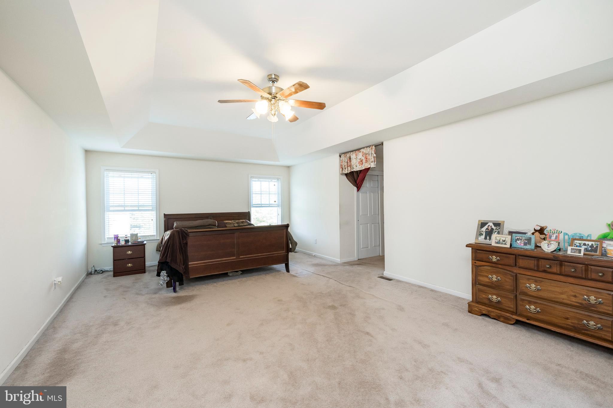 877 Church Road Harleysville, PA 19438 - Photo 17 of 48 a bedroom with a bed and a chandelier