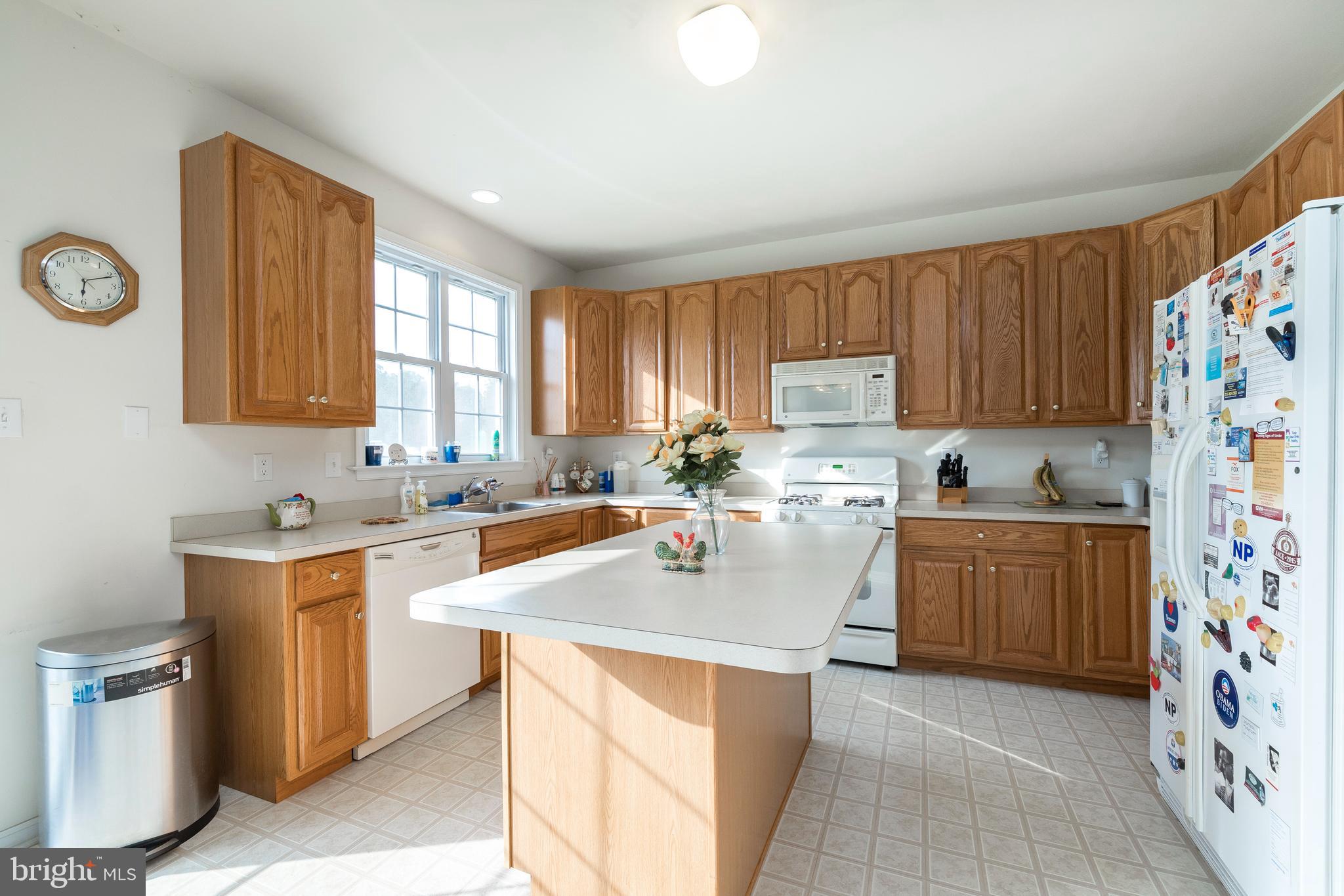877 Church Road Harleysville, PA 19438 - Photo 22 of 48 a kitchen with stainless steel appliances granite countertop a sink stove top oven and refrigerator