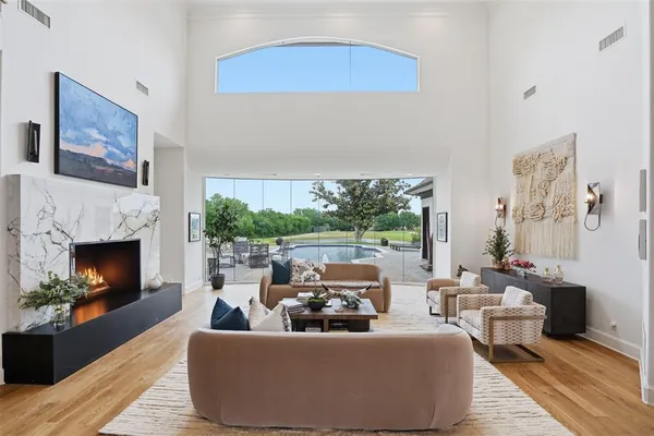 a living room with furniture a large window and a flat screen tv