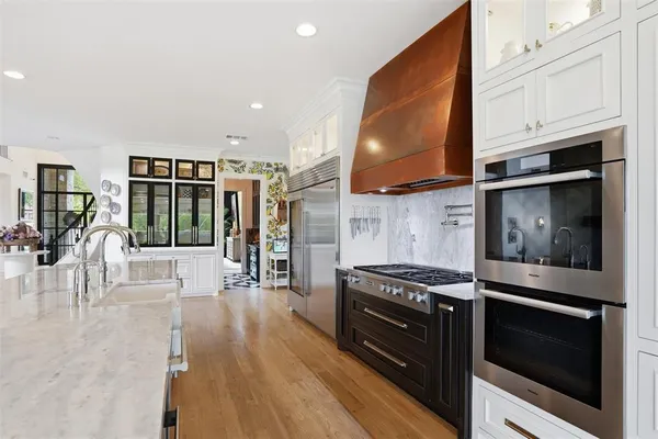a view of walk in closet with wooden floor and a chandelier
