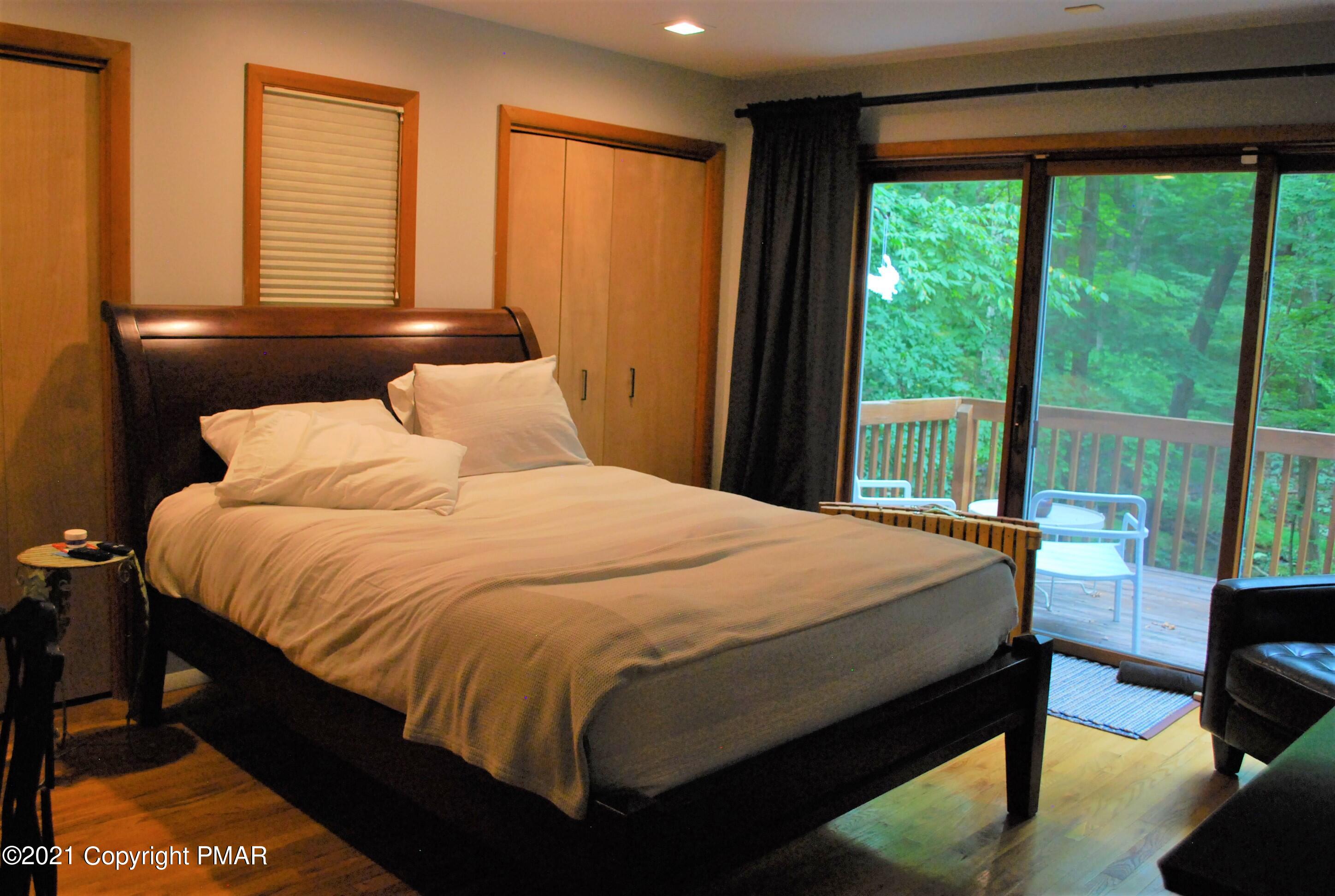 178 Edinburgh Road Bushkill, PA 18324 - Photo 17 of 54 a bedroom with a bed and wooden floor