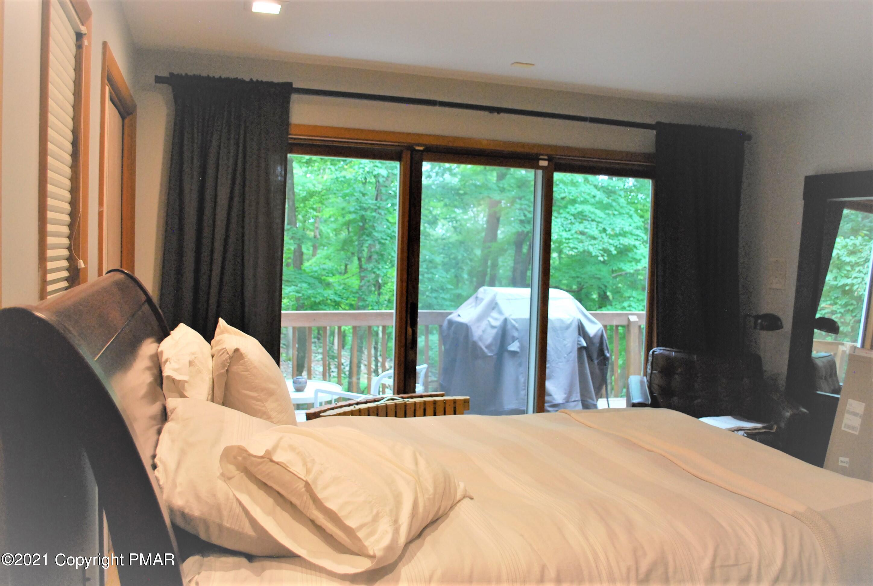 178 Edinburgh Road Bushkill, PA 18324 - Photo 18 of 54 a bed sitting in a bedroom next to a window