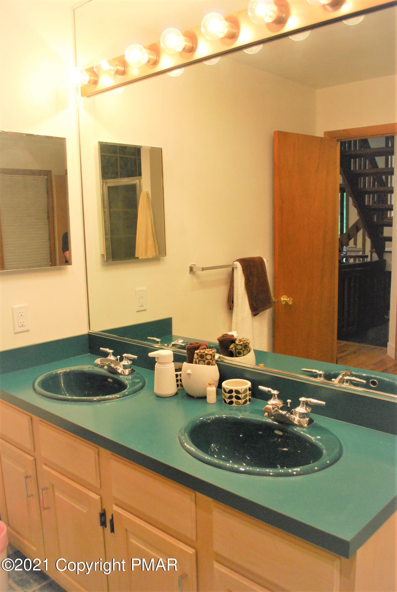 178 Edinburgh Road Bushkill, PA 18324 - Photo 21 of 54 a bathroom with a sink and a mirror