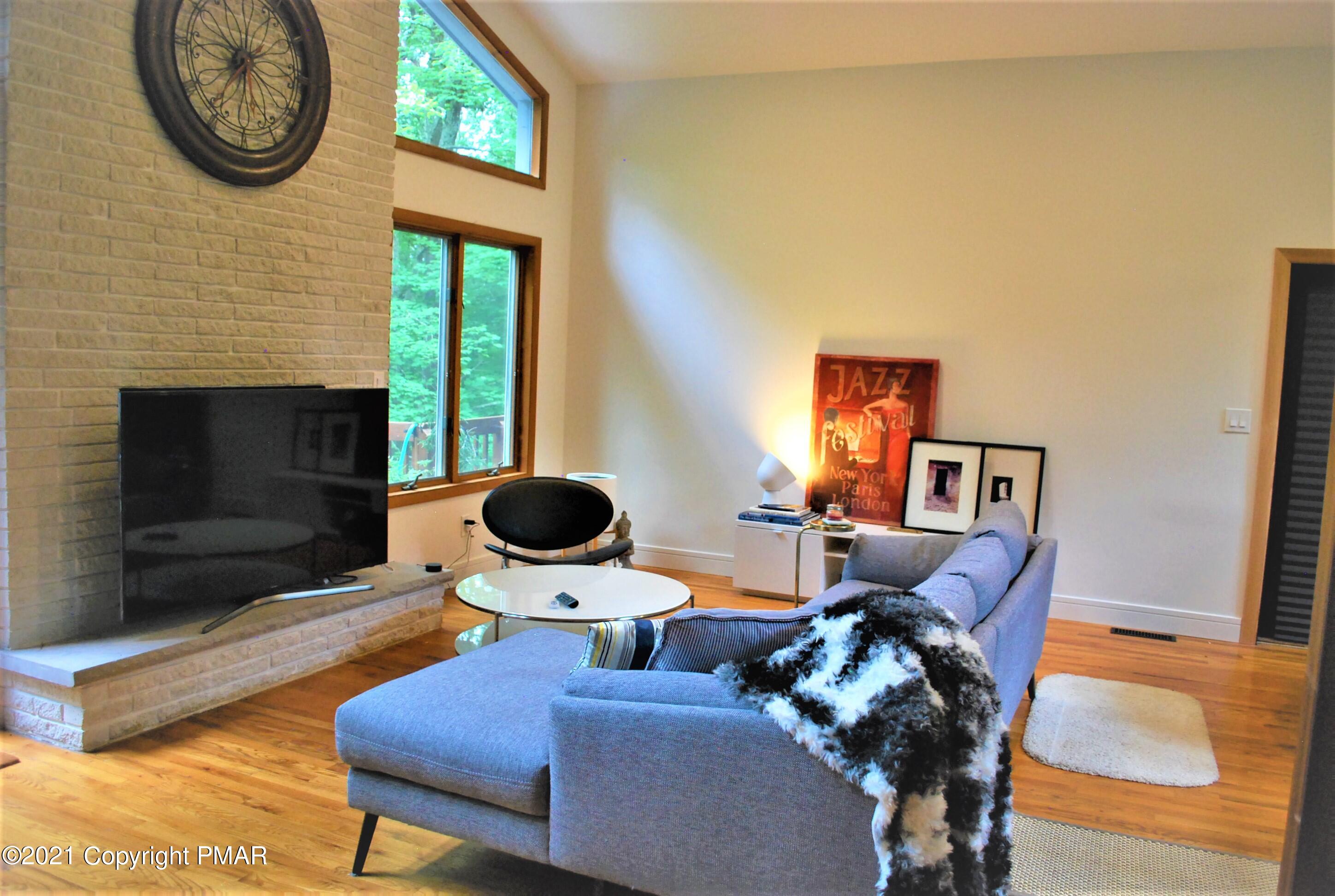 178 Edinburgh Road Bushkill, PA 18324 - Photo 3 of 54 a living room with furniture and a fireplace