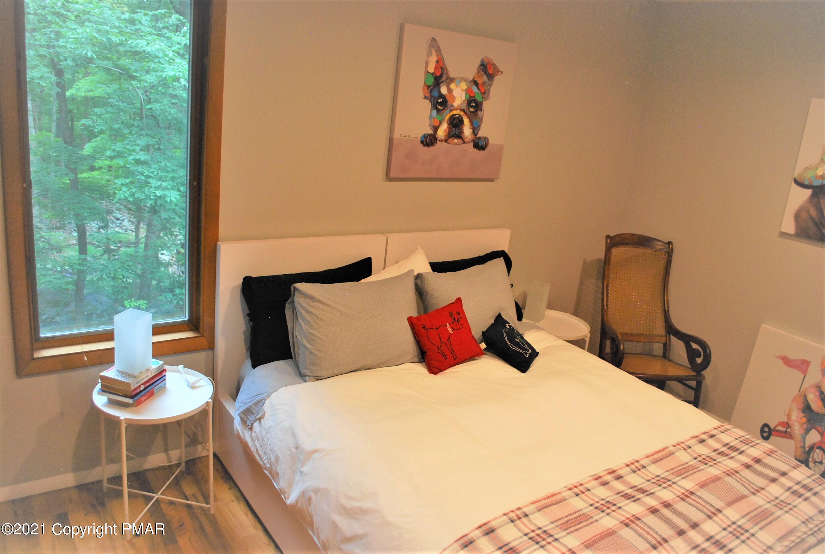178 Edinburgh Road Bushkill, PA 18324 - Photo 33 of 54 a bedroom with a bed and wooden floor