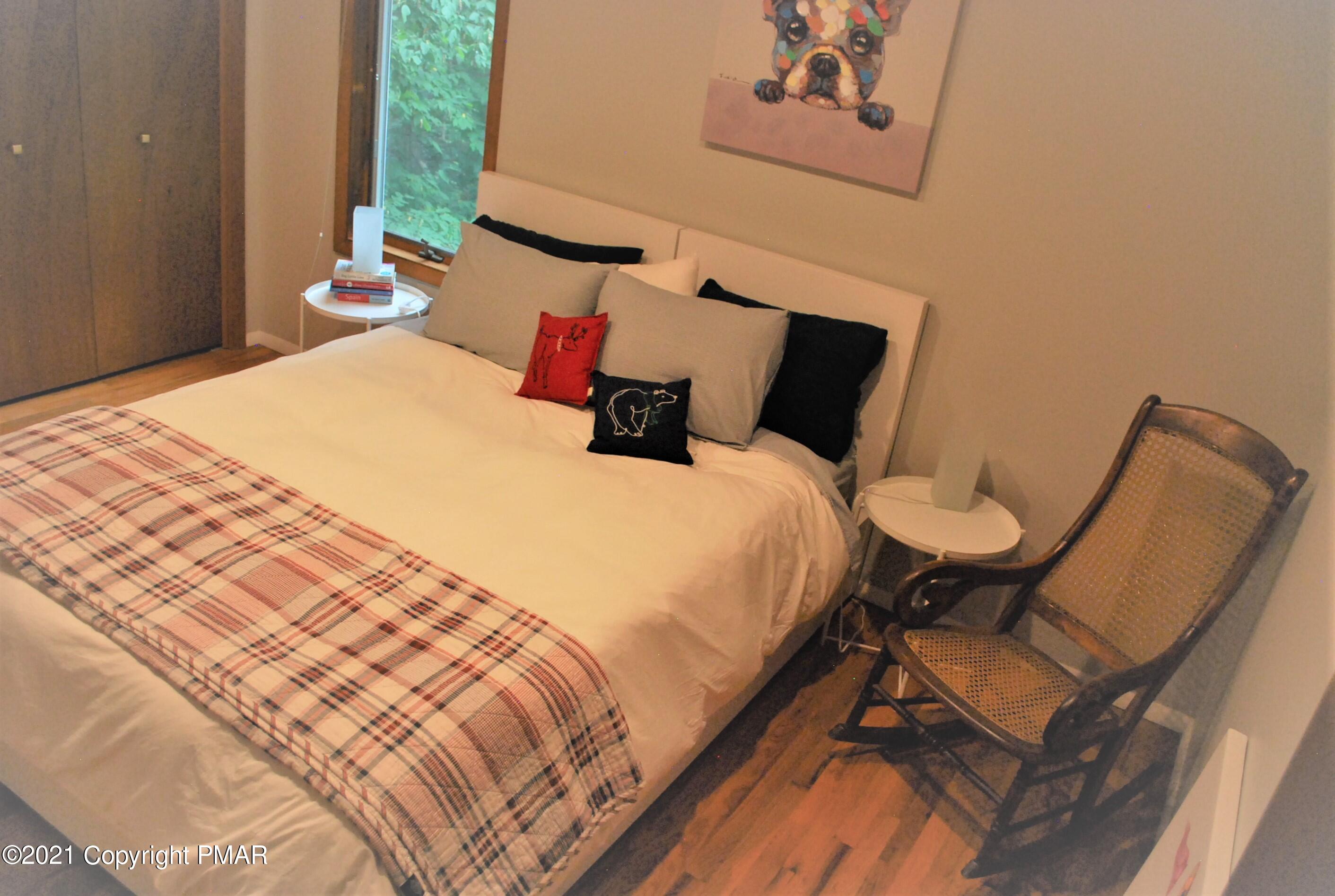 178 Edinburgh Road Bushkill, PA 18324 - Photo 34 of 54 a bed sitting in a bedroom next to a window with a lamp