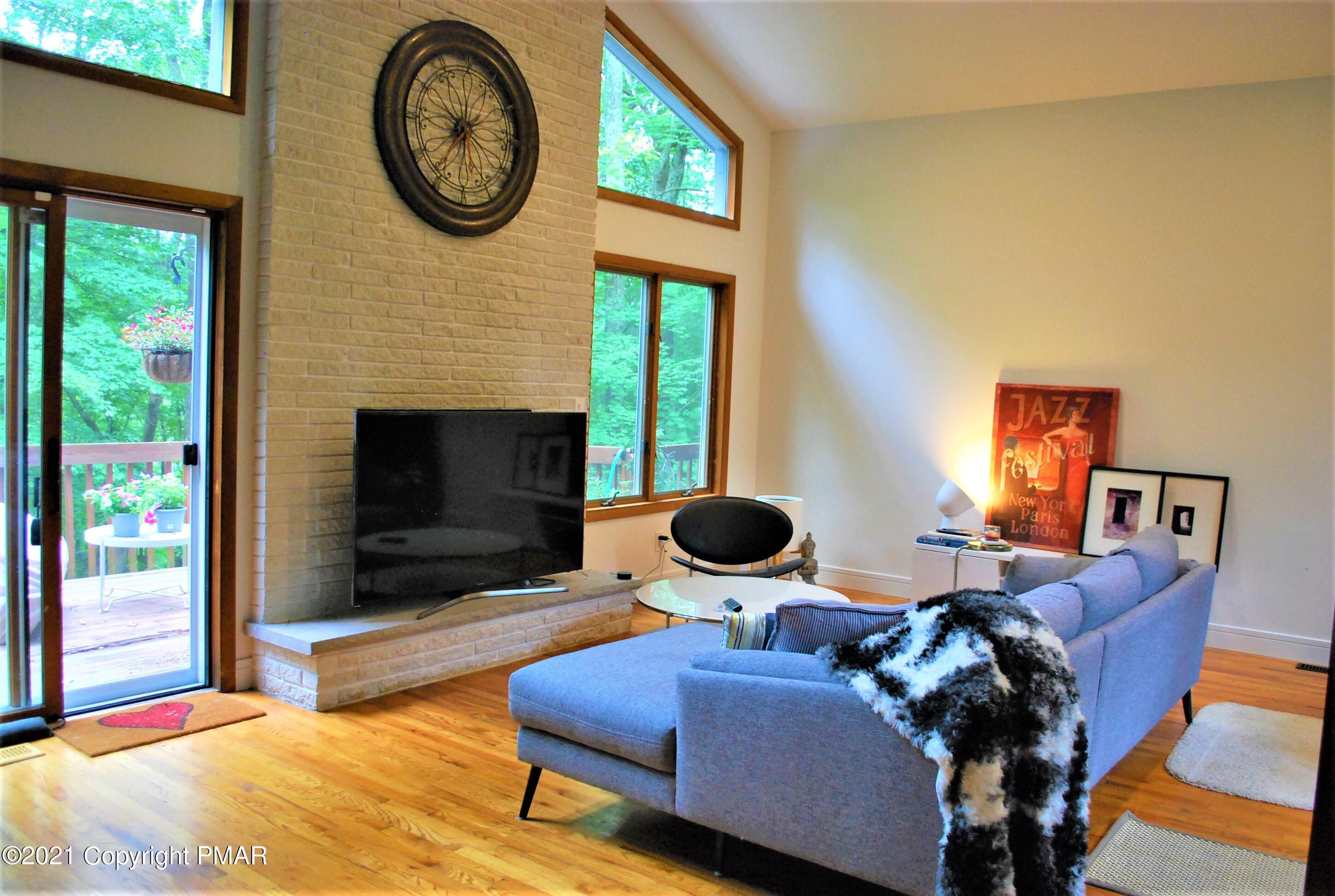178 Edinburgh Road Bushkill, PA 18324 - Photo 4 of 54 a living room with furniture a fireplace and a large window