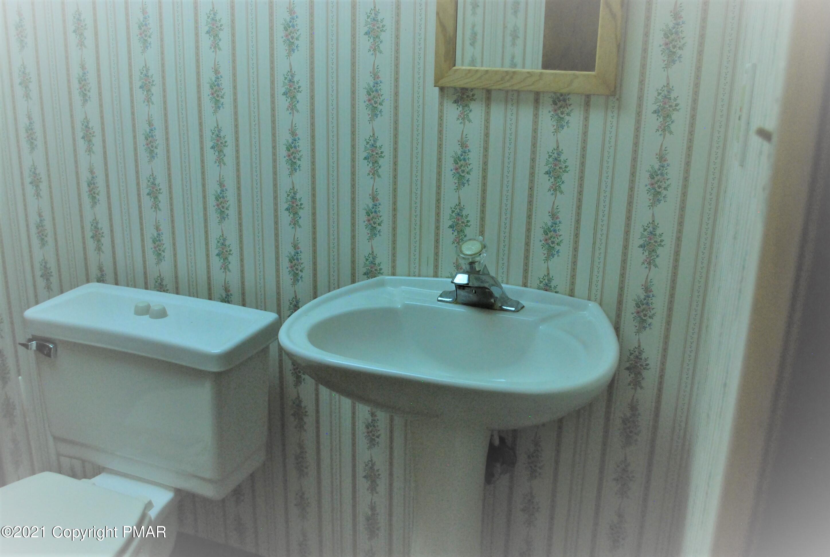178 Edinburgh Road Bushkill, PA 18324 - Photo 41 of 54 a bathroom with a sink and mirror