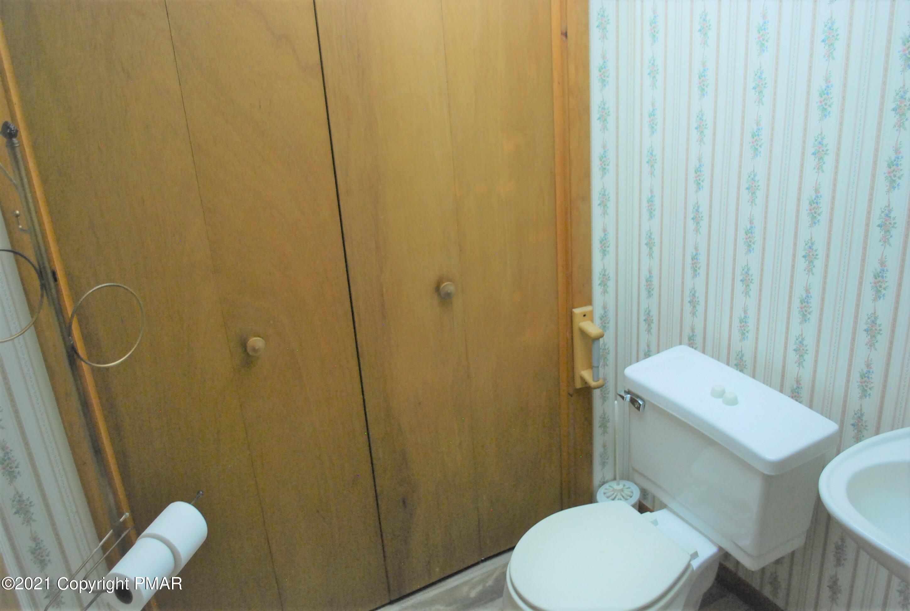 178 Edinburgh Road Bushkill, PA 18324 - Photo 43 of 54 a white toilet sitting next to a bathroom sink and toilet