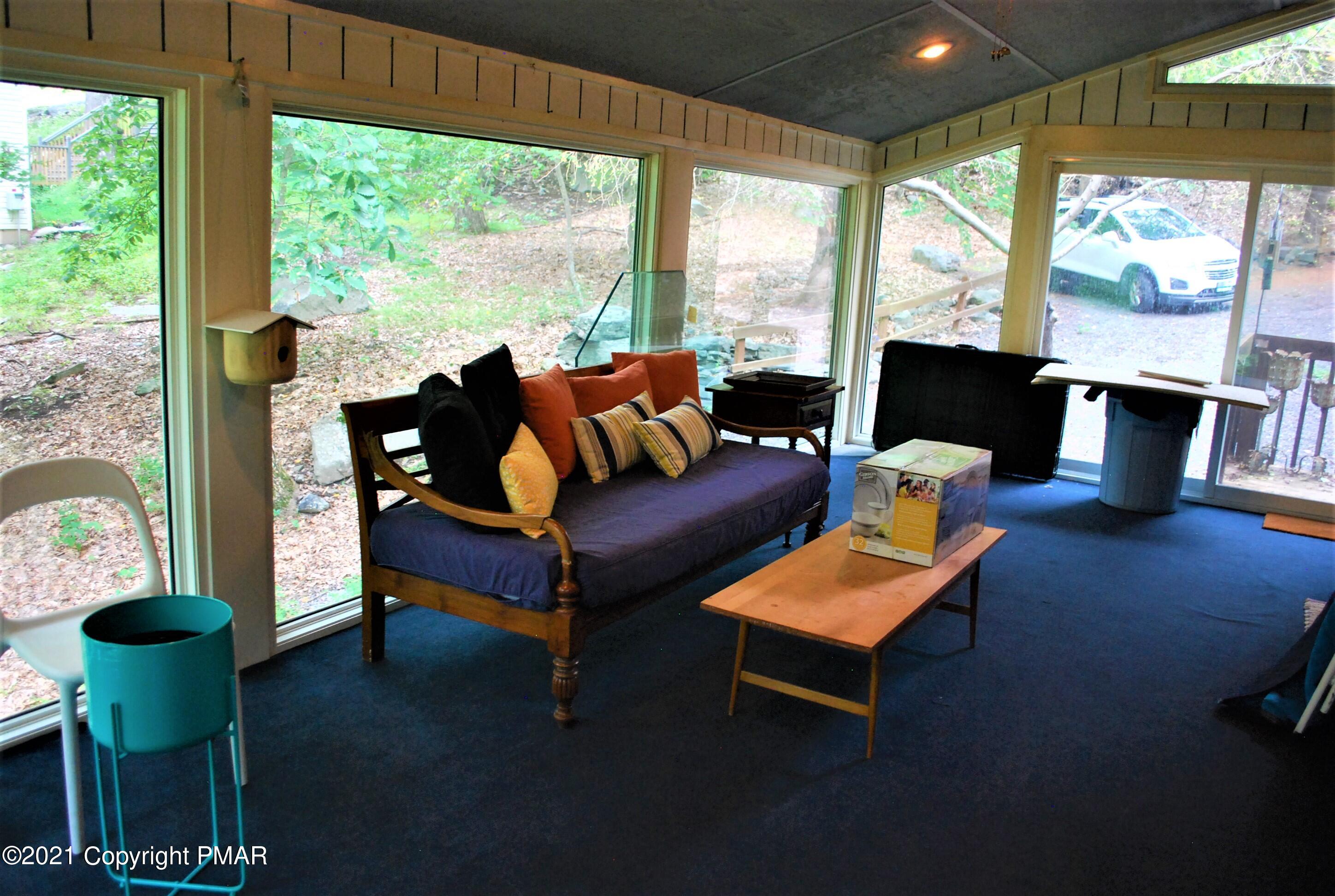 178 Edinburgh Road Bushkill, PA 18324 - Photo 46 of 54 a living room with furniture and a floor to ceiling window