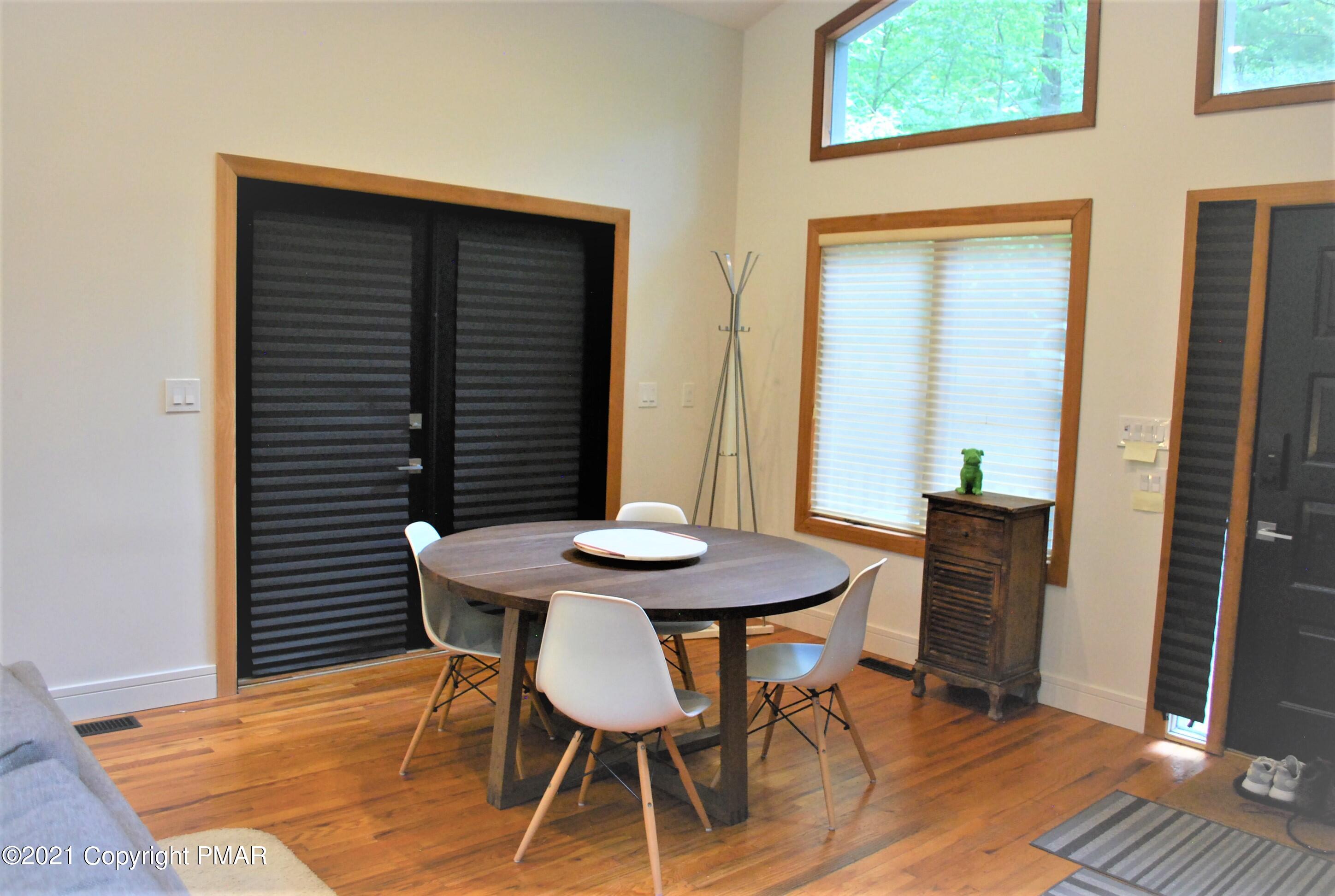 178 Edinburgh Road Bushkill, PA 18324 - Photo 9 of 54 a view of a dining table and chairs in patio of the house