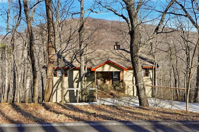 a front view of a house with trees