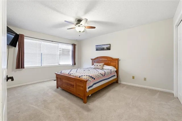 a bedroom with a bed and window