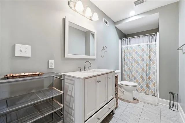 a view of bathroom with a sink toilet and shower