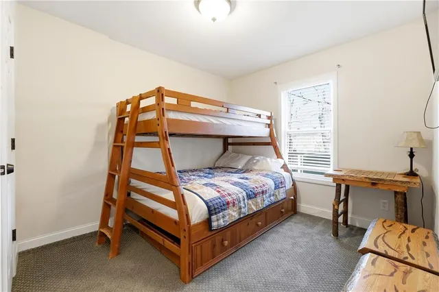a bedroom with a bed and a desk