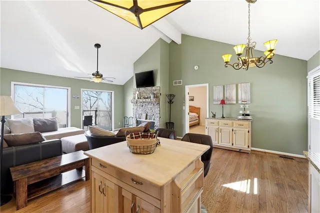 a view of a dining room with furniture a chandelier and wooden floor