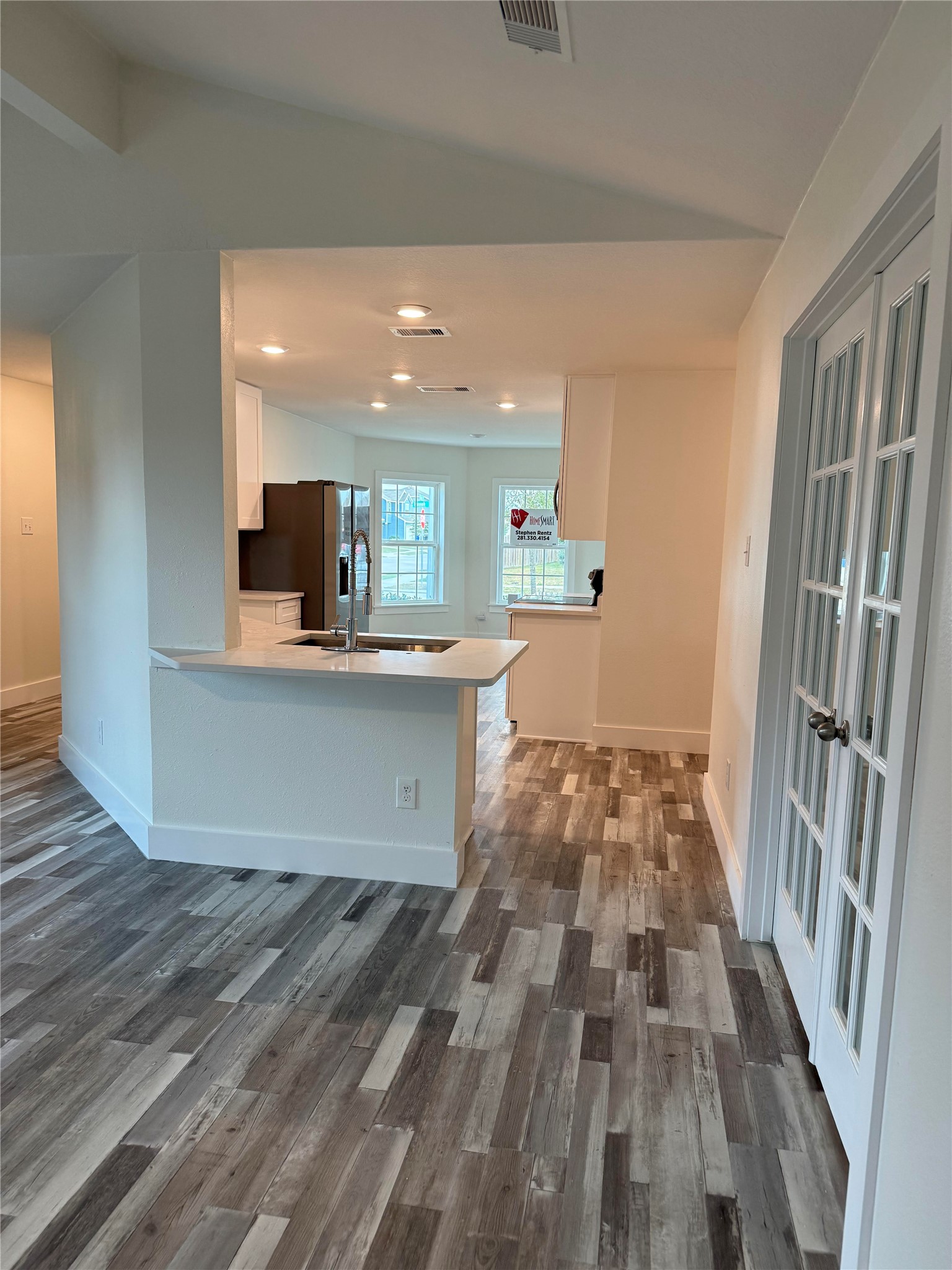 8419 Hannah Rd Cove Cove, TX 77523 - Photo 5 of 28 a view of a kitchen with kitchen island wooden floor center island and stainless steel appliances