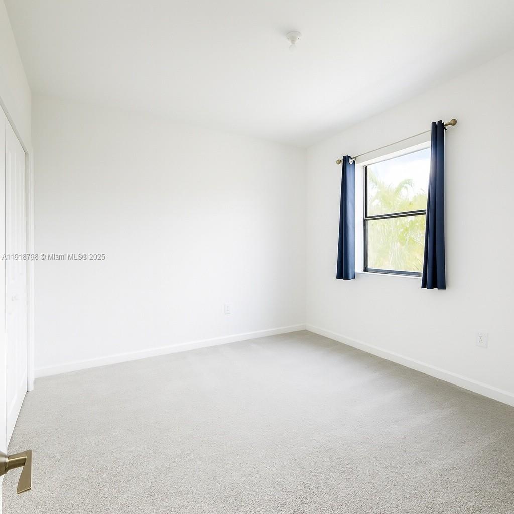 25564 Southwest 108th Avenue, Unit 25564 Homestead, FL 33032 - Photo 12 of 17 an empty room with a window