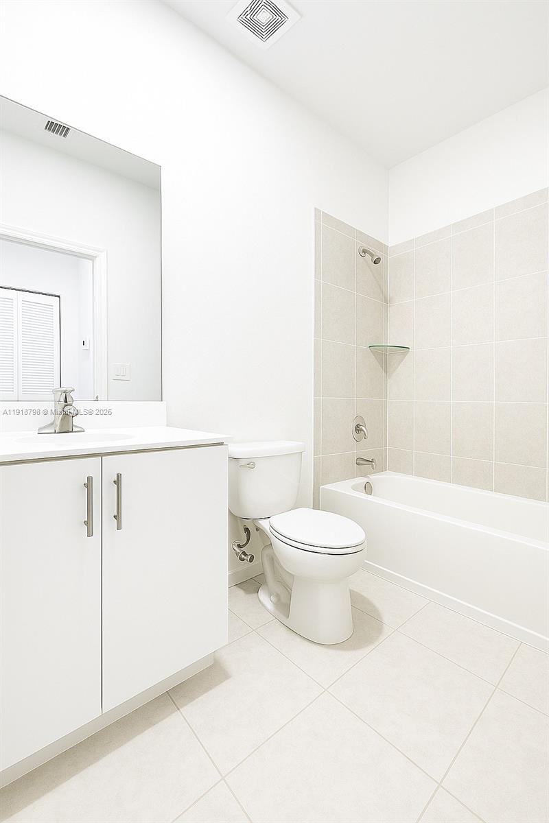 25564 Southwest 108th Avenue, Unit 25564 Homestead, FL 33032 - Photo 14 of 17 a bathroom with a toilet a sink and a bathtub