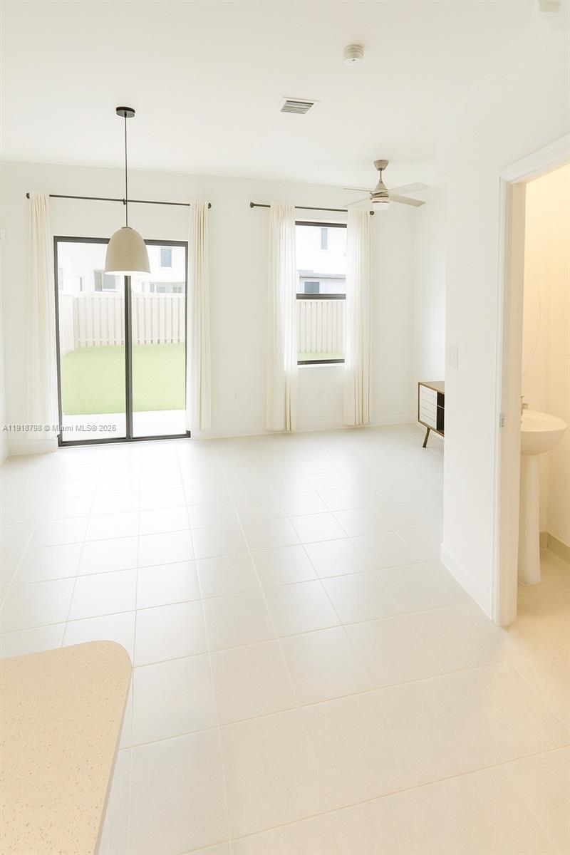 25564 Southwest 108th Avenue, Unit 25564 Homestead, FL 33032 - Photo 2 of 17 a view of a room with window and wooden floor