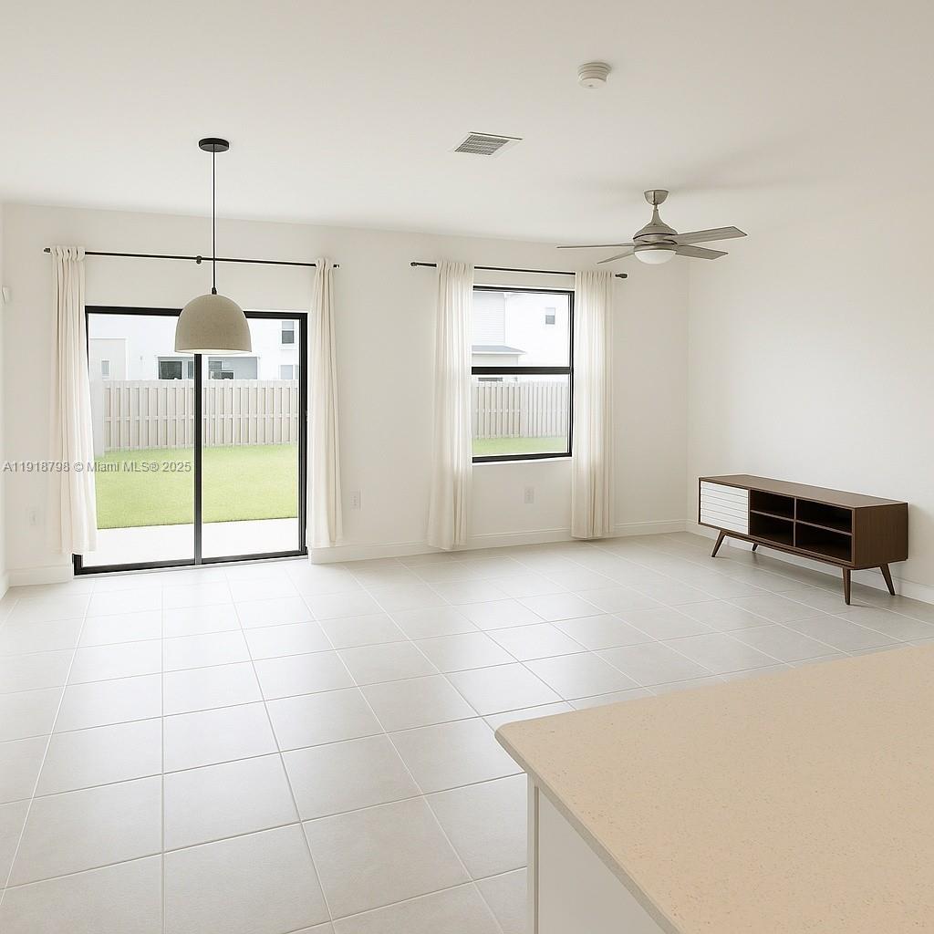 25564 Southwest 108th Avenue, Unit 25564 Homestead, FL 33032 - Photo 3 of 17 a view of an empty room with a window