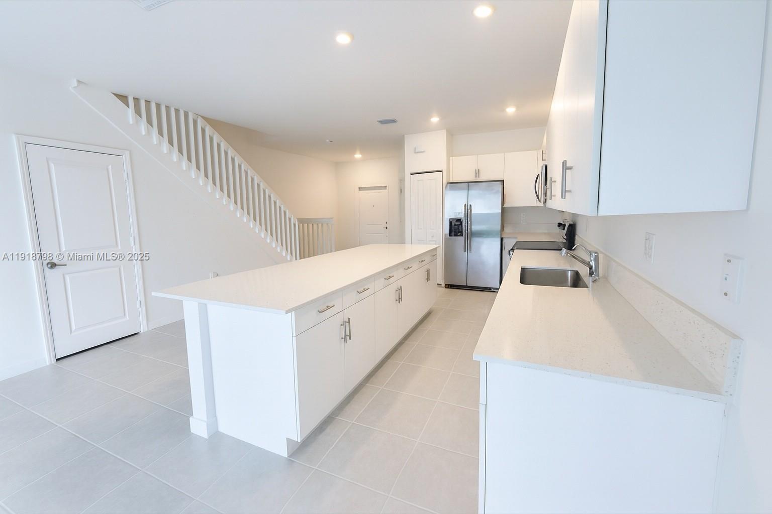 25564 Southwest 108th Avenue, Unit 25564 Homestead, FL 33032 - Photo 5 of 17 a view of a kitchen with furniture and cabinets