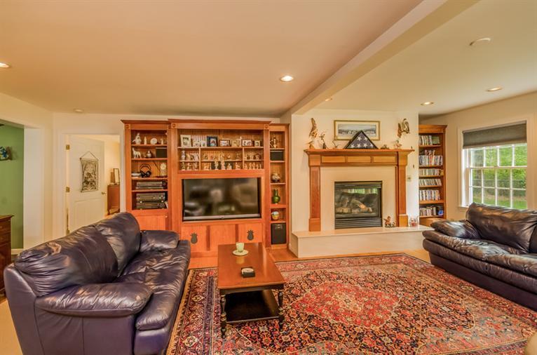 53 Sandy Neck Road East Sandwich, MA 02537 - Photo 13 of 28 a living room with furniture and a fireplace