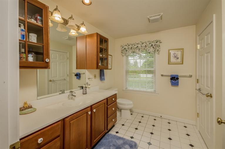 53 Sandy Neck Road East Sandwich, MA 02537 - Photo 16 of 28 a bathroom with a double vanity sink a mirror a shower and a bathtub