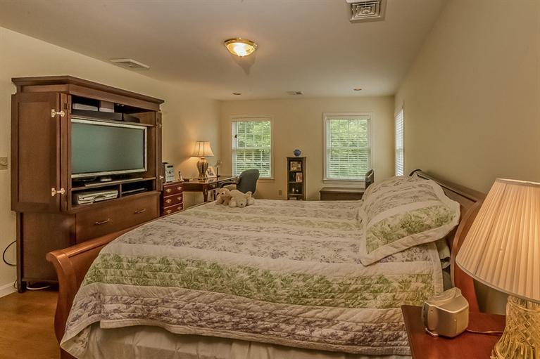 53 Sandy Neck Road East Sandwich, MA 02537 - Photo 18 of 28 a bedroom with a bed and tv