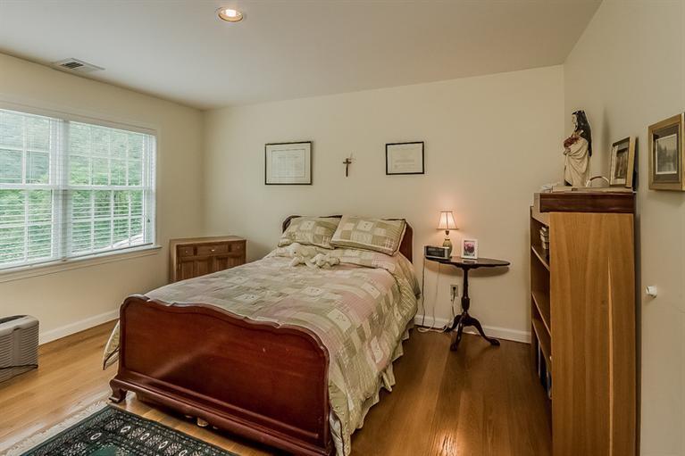 53 Sandy Neck Road East Sandwich, MA 02537 - Photo 20 of 28 a bedroom with a bed and wooden floor