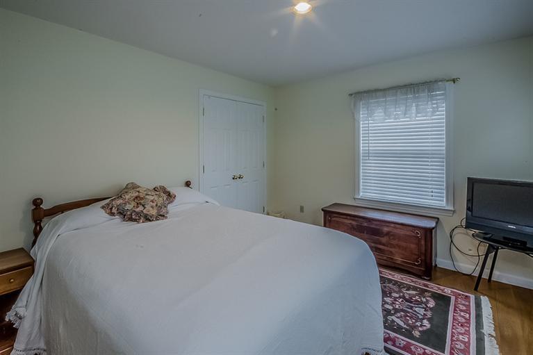 53 Sandy Neck Road East Sandwich, MA 02537 - Photo 21 of 28 a bedroom with a bed and flat screen tv