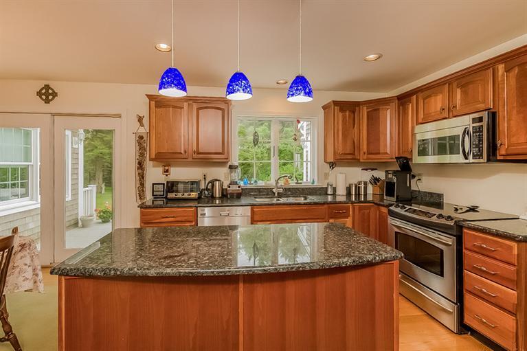 53 Sandy Neck Road East Sandwich, MA 02537 - Photo 10 of 28 a kitchen with granite countertop a stove a sink and a microwave