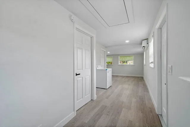 a view of a hallway with wooden floor