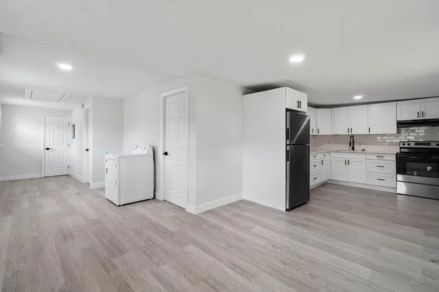 a view of a kitchen with wooden floor