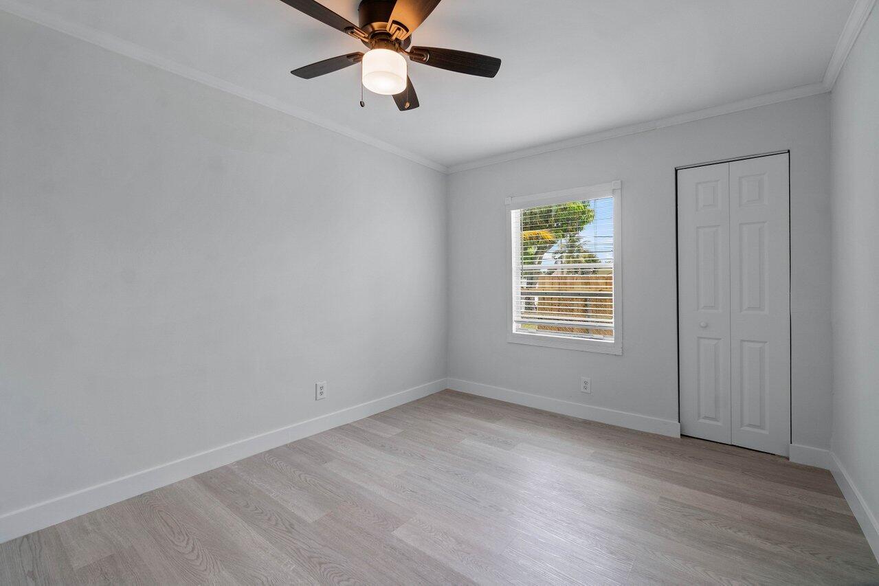 137 Southwest 9th Avenue Delray Beach, FL 33444 - Photo 16 of 27 wooden floor in an empty room with a window