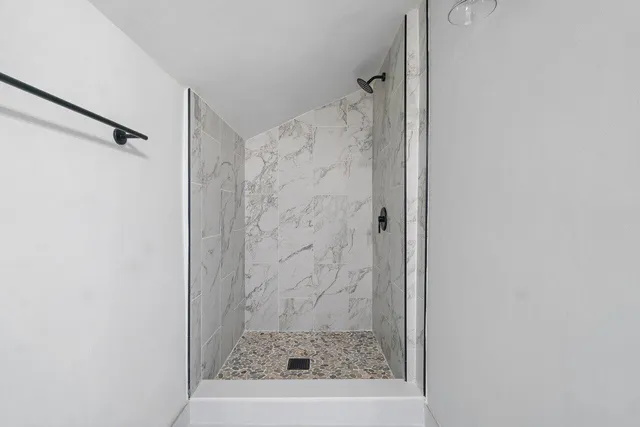 a bathroom with a toilet and a shower