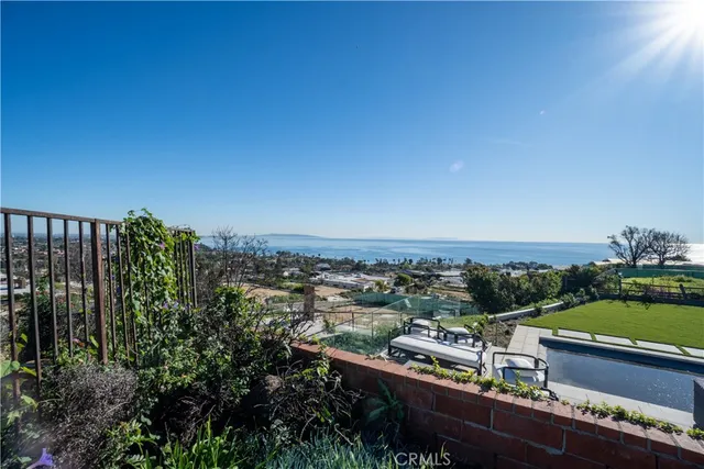 a view of a street with a building and palm trees