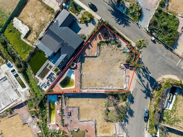 an aerial view of a house with a yard and potted plants