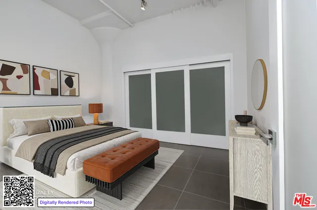 a bedroom with a bed and a mirror