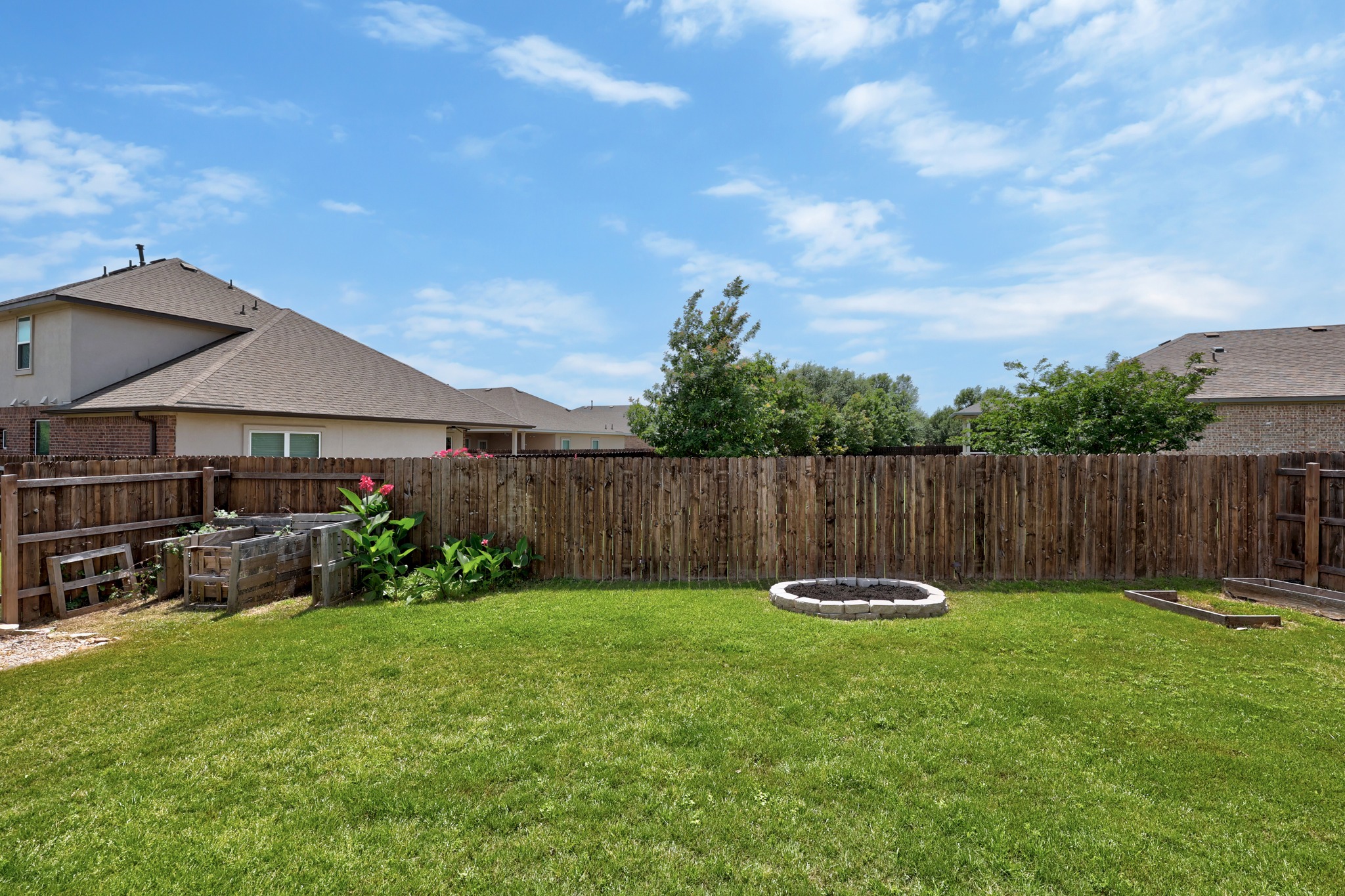 2413 Starhill Ranch Street Georgetown, TX 78628 - Photo 31 of 40 a front view of a house with garden and a yard