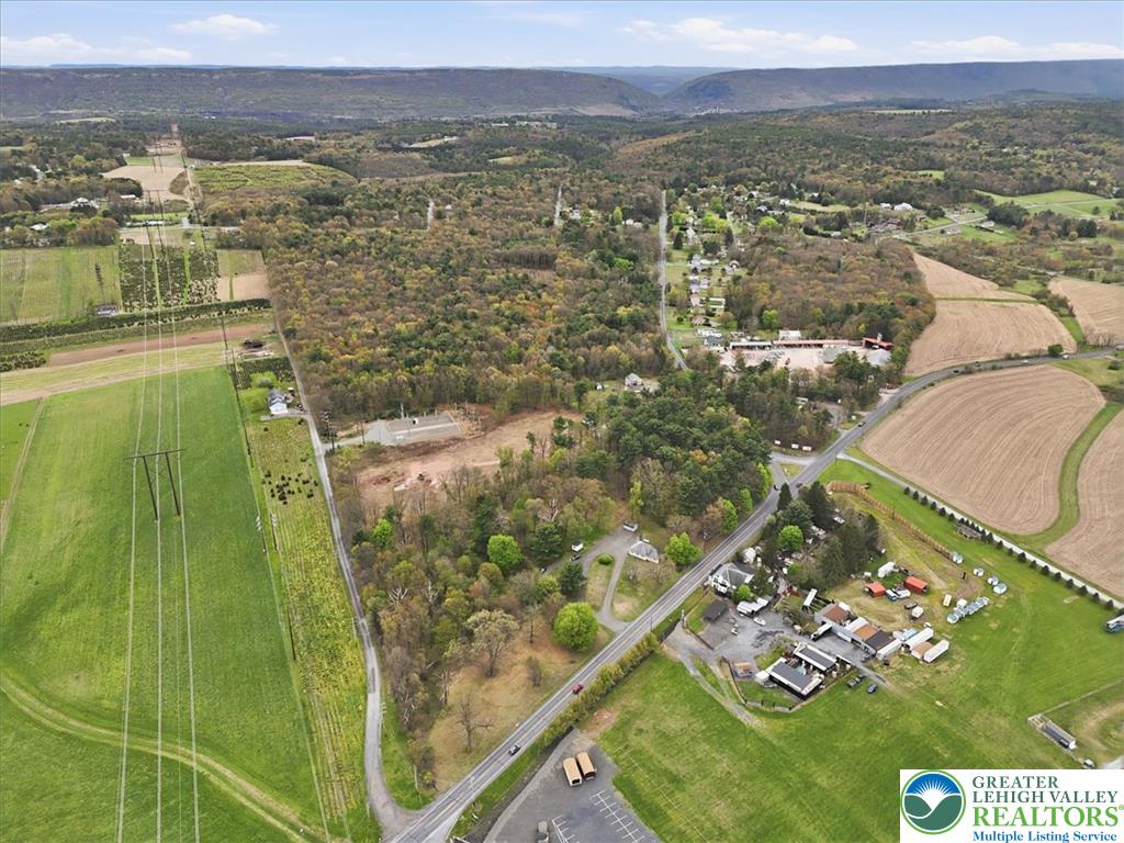 Interchange Road Lehighton, PA 18235 - Photo 8 of 40 An aerial perspective reveals the property's prime location amidst fields, roadways, and distant hills.