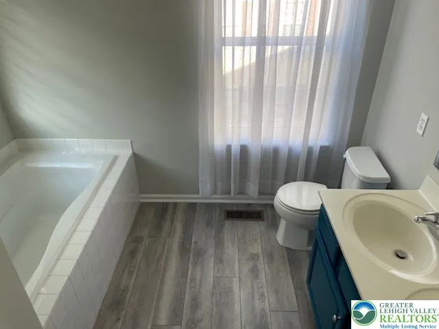 a bathroom with a sink a toilet and tub