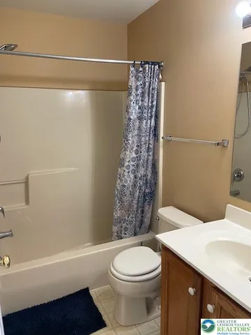 a bathroom with a toilet a sink and bathtub
