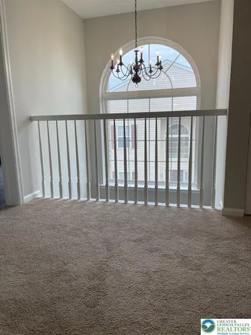 a view of a hallway to a livingroom