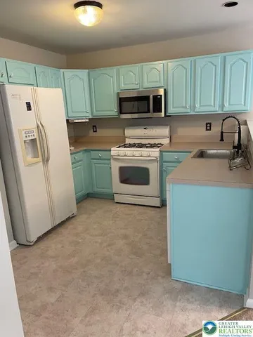 a kitchen with a refrigerator sink and stove
