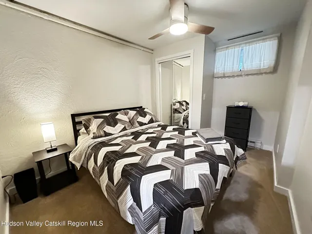 a bedroom with a bed and a chair