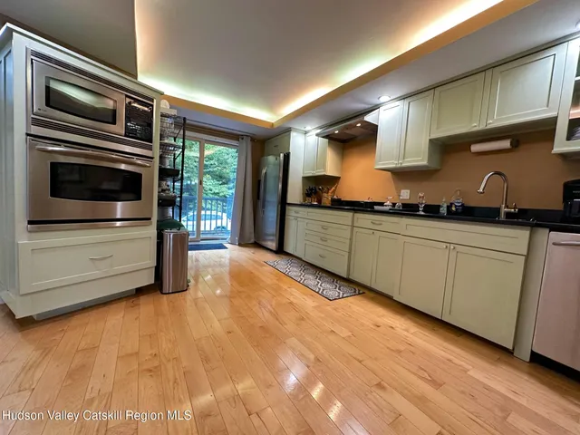 a kitchen with stainless steel appliances a stove a sink and cabinets