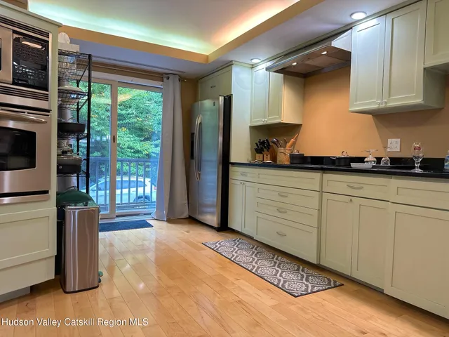 a kitchen with stainless steel appliances granite countertop a stove a sink and a refrigerator